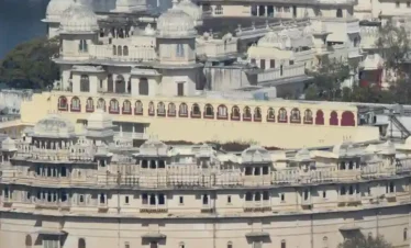 Majestic view of City Palace overlooking Lake Pichola with intricate domes and royal architecture in Udaipur.
