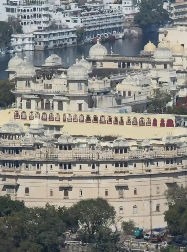 Majestic view of City Palace overlooking Lake Pichola with intricate domes and royal architecture in Udaipur.