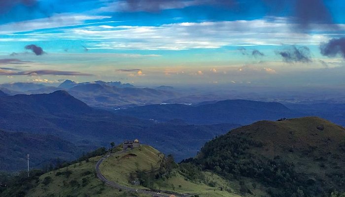 Ponmudi hill station Kerala with misty mountains and winding roads